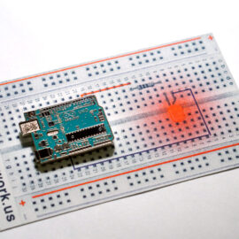 Arduino Pin Enamel pin with Risograph printed back.